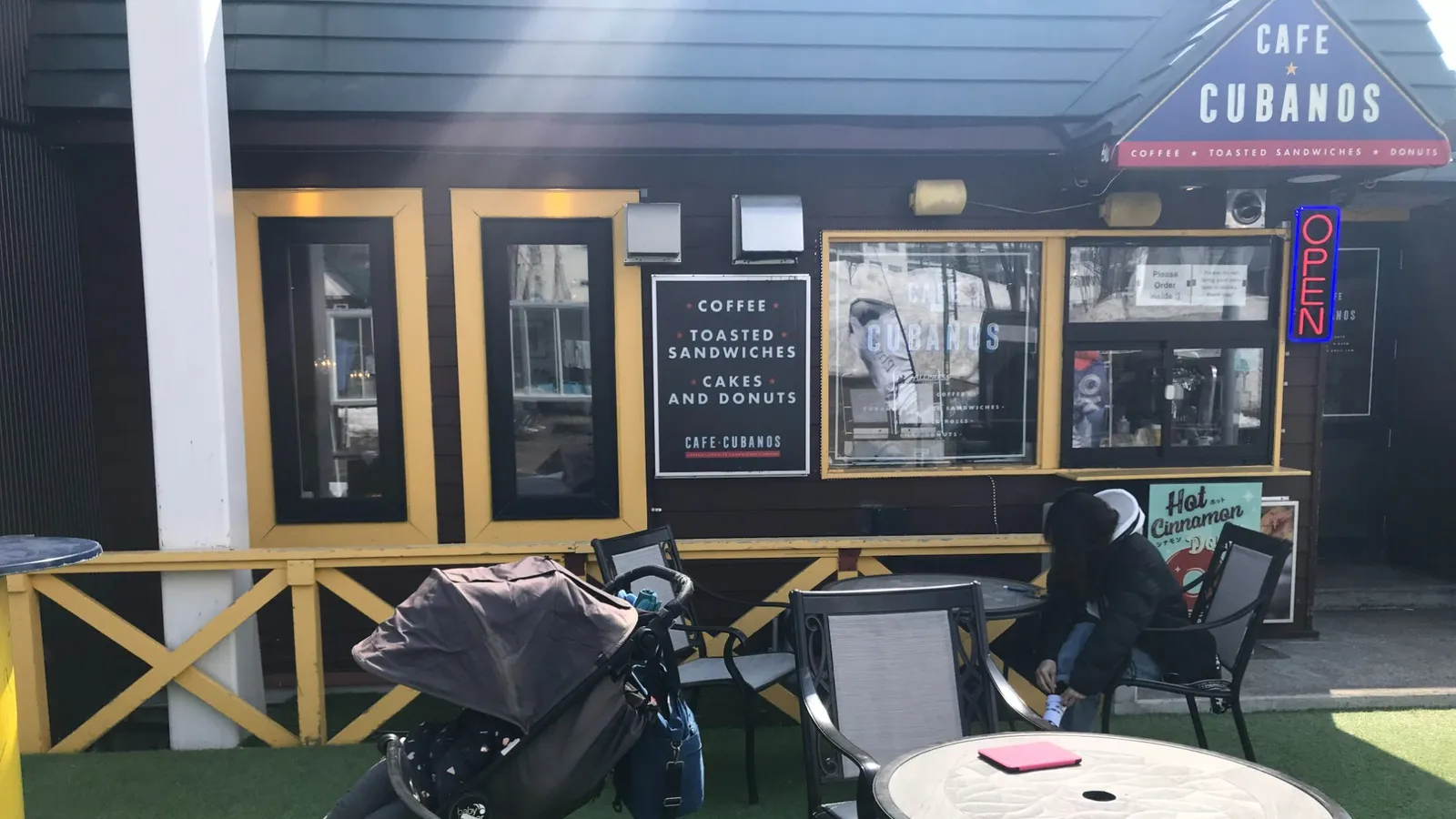 Toddler asleep in stroller at Cafe Cubanos in Niseko, Japan