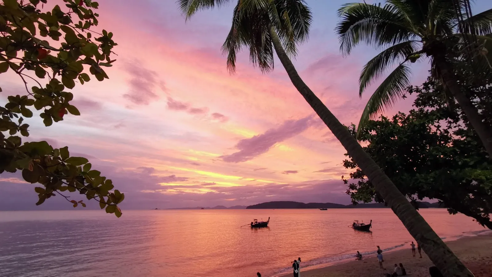 Sunset from Ao Nang Beach with longtail boats, Krabi Thailand